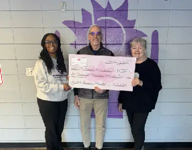 Staff members presenting a check to Milwaukee Women's Center.