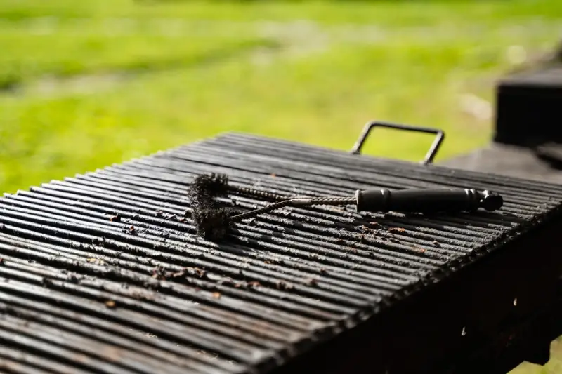 Chicken being cooked on an outdoor charcoal grill